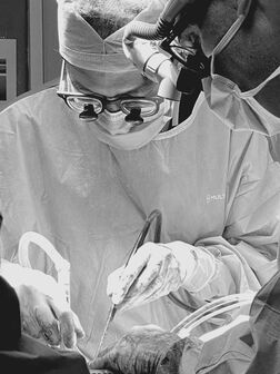 Black and White Photo of Surgeon Performing Laparoscopic Surgery